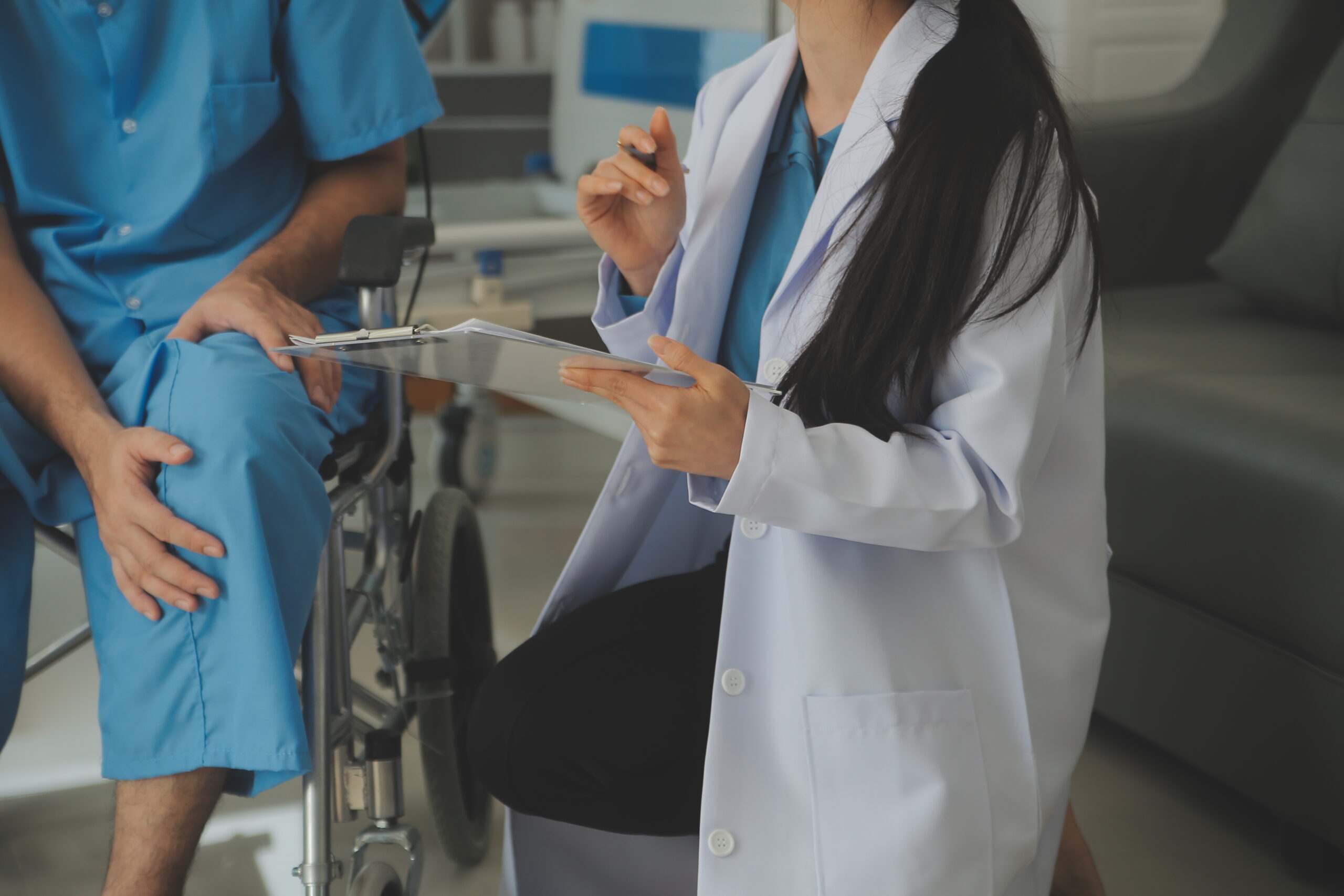 young asian physical therapist working with senior woman on walking with a walker